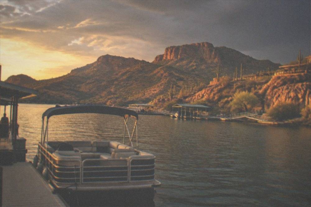 Golden late afternoon light on a desert lake and the rocky walls above the shoreline