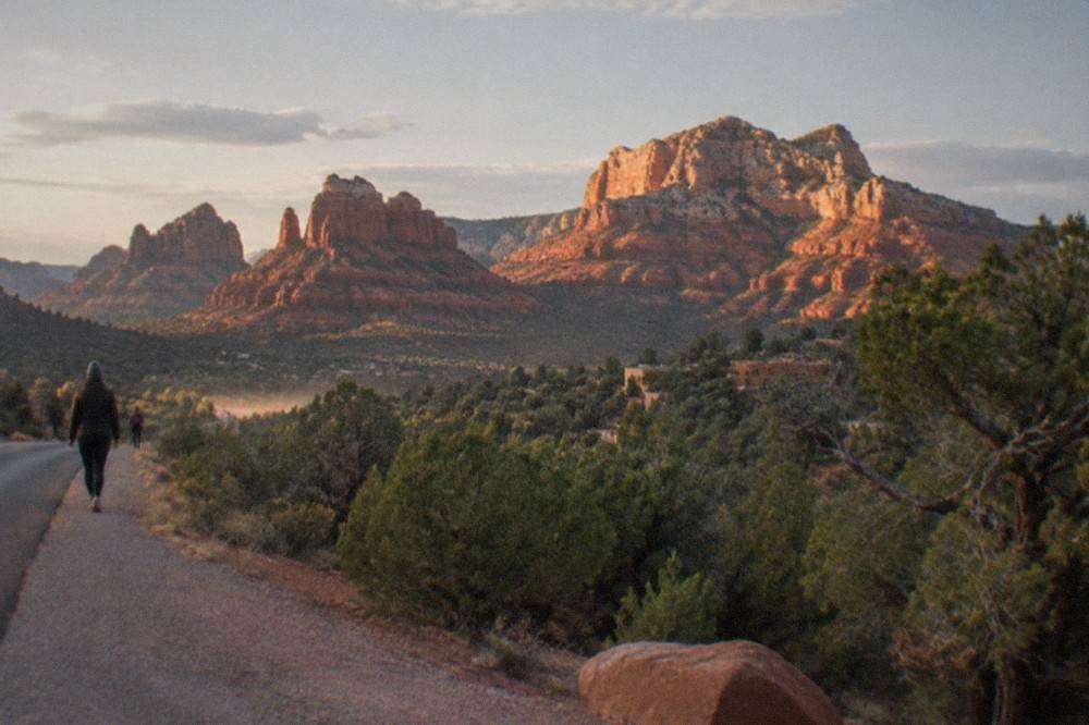 Red sandstone formations rising above tree covered hills near Sedona