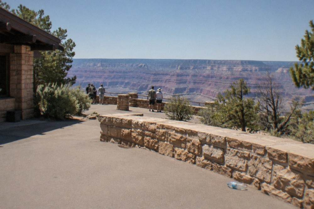 Grand Canyon South Rim viewpoint with expansive canyon under a blue sky
