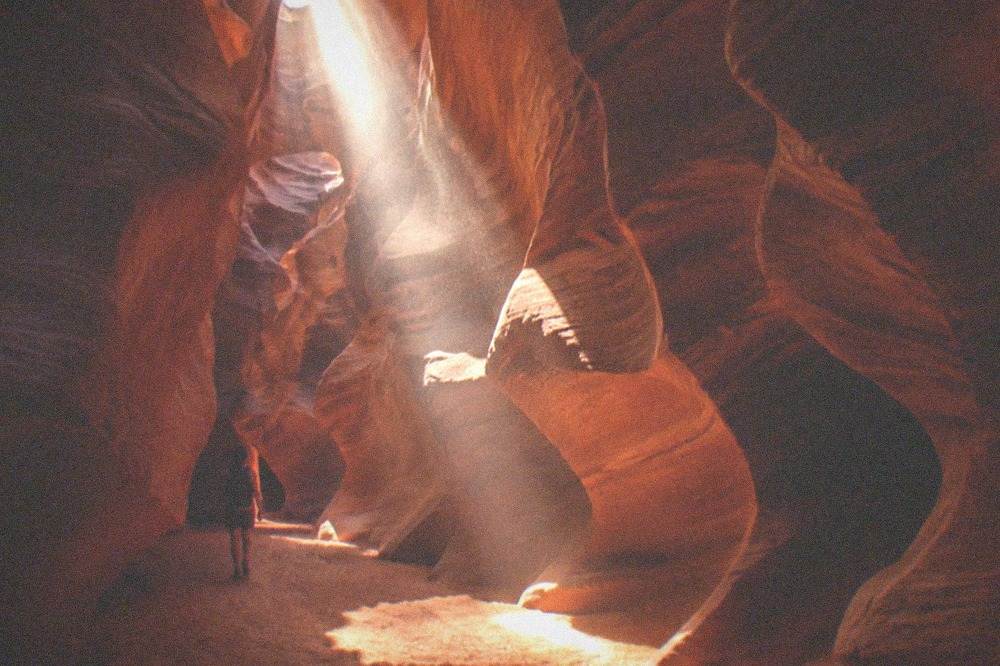 Upper Antelope Canyon with a sunbeam piercing through narrow sandstone walls