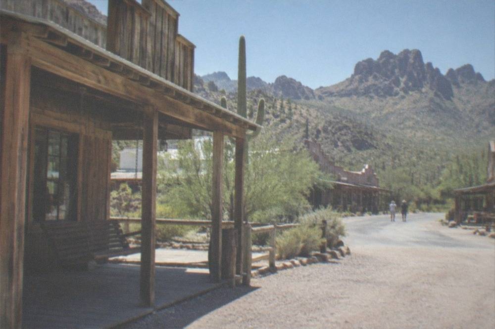 Old western-style buildings at a desert ghost town stop along the Apache Trail