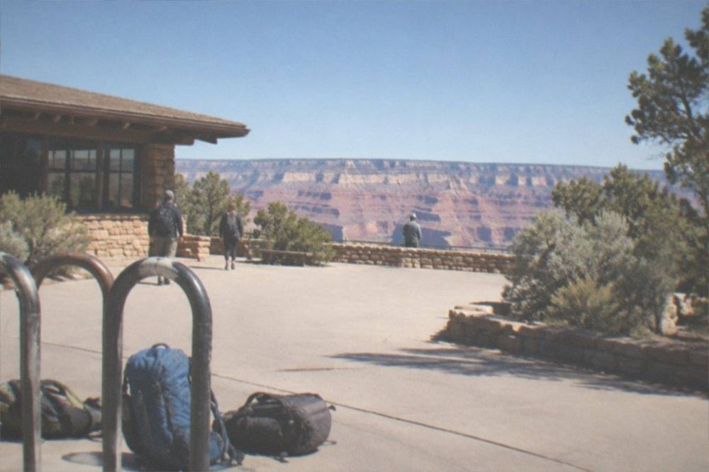 Layered rock formations at a Grand Canyon viewpoint under midday sun
