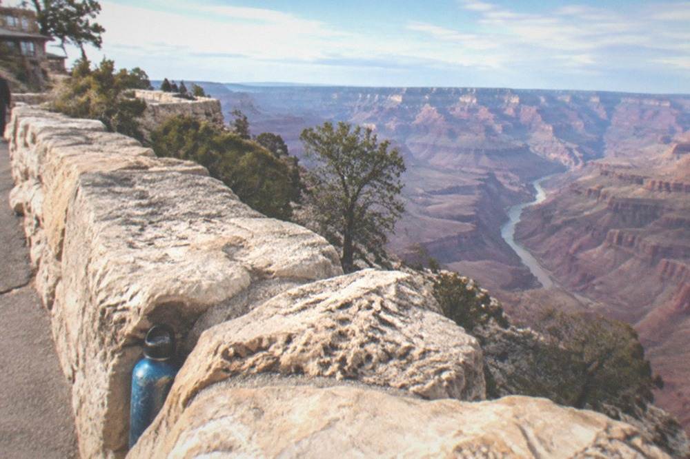 Grand Canyon rim viewpoint with the river gorge visible in the distance