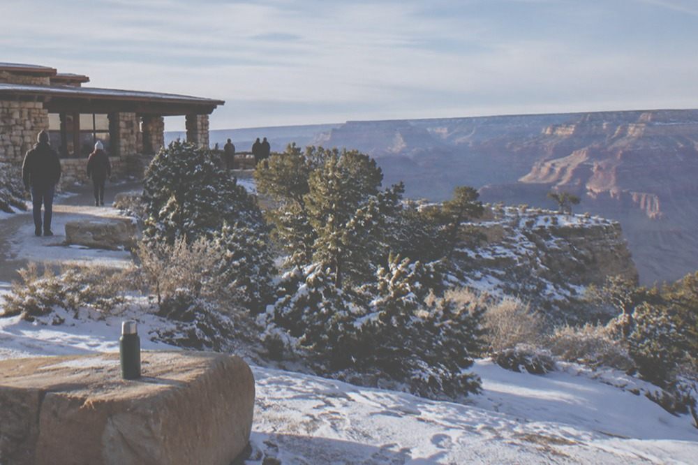 A sweeping overlook above a wide desert valley with layered rock in the distance