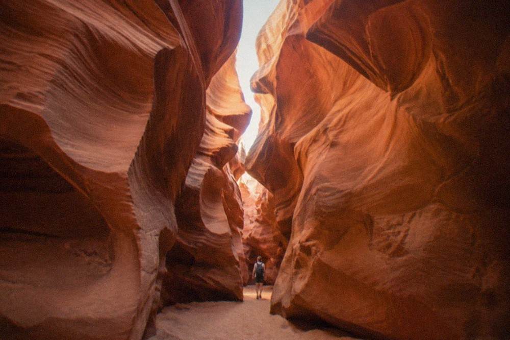 Twisted orange sandstone walls of Antelope Canyon rising toward a narrow slit of sky