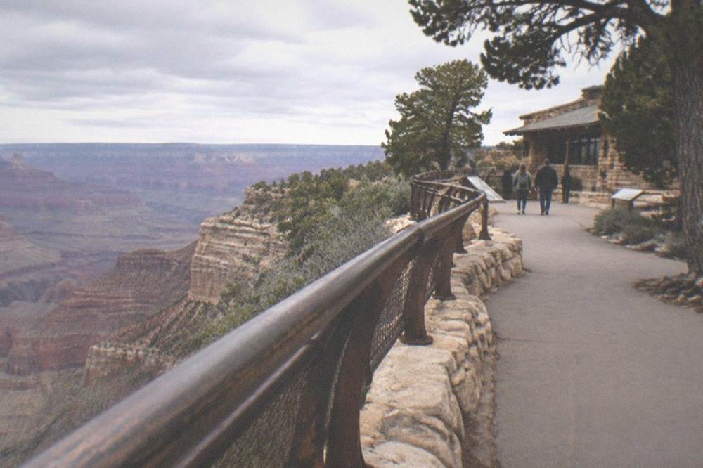 A canyon viewpoint walkway with railings along the South Rim