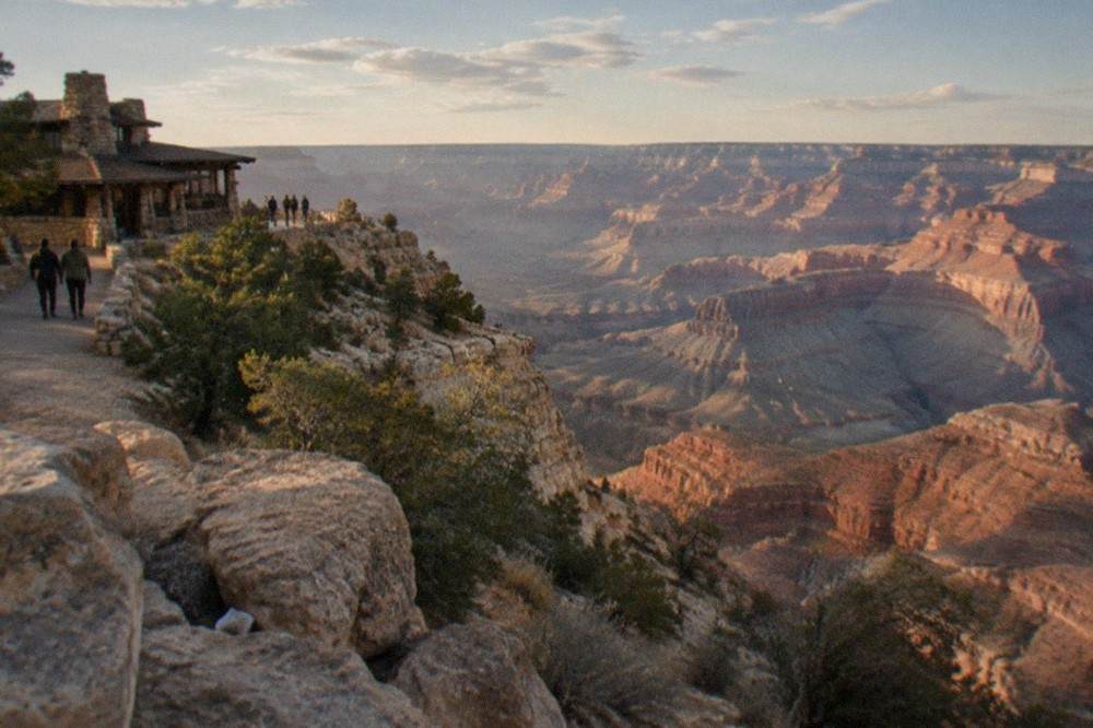 Wide view of the Grand Canyon from the South Rim with layered red rock formations under a bright sky