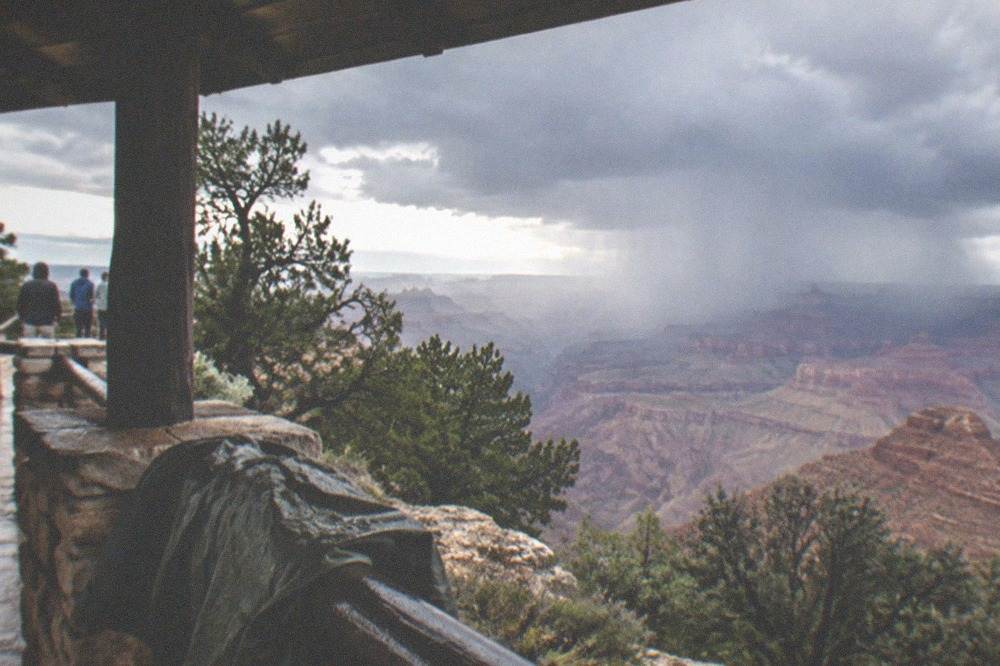 Storm clouds gathering over layered canyon walls at the South Rim
