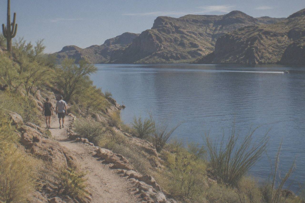 Canyon Lake ringed by desert hills along the Apache Trail, calm water reflecting the mountains above Tortilla Flat.